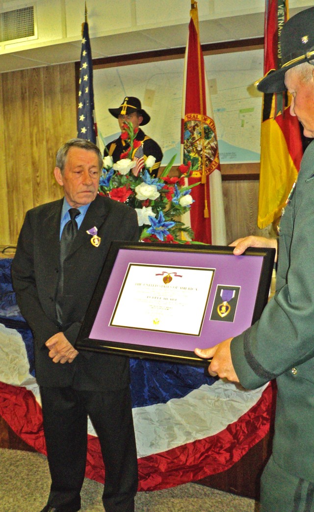 PORT ST. JOE. Fla. - Irey Weeks (left), a former specialist with E Company, 5th Battalion, 7th Cavalry Regiment, 1st Cavalry Division (1970), receives his Purple Heart from Maj. Gen. (Ret.) James Simmons, former deputy commanding general, 1st...