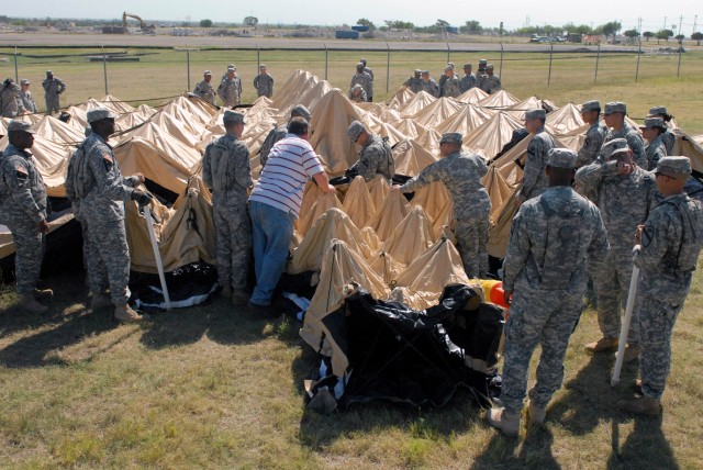 FORT HOOD, Texas - Soldiers assigned to the 1st Brigade Combat Team, 1st Cavalry Division, assemble the main tent used during the brigade Tactical Operations Center Exercise, here, Aug. 23. This exercise ensures the brigade headquarters has a fully f...
