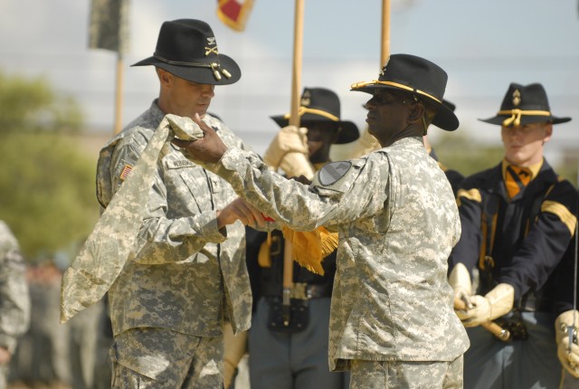 FORT HOOD, Texas- Col. Brian Winski (left), commander of the 4th Brigade Combat Team, 1st Cavalry Division, and 4th BCT Command Sgt. Maj. Antoine Overstreet, case the Long Knife colors for the brigade's deployment overseas in support of Operation...