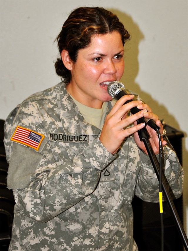 FORT HOOD, Texas--Pfc. Amarilys Rodriguez, from Puerto Rico, an orderly room clerk for the 67th Forward Support Company, 1st Battalion, 21st Field Artillery Regiment, sings during a practice with the Los Cavalleros at the 1st Cavalry Division Band...