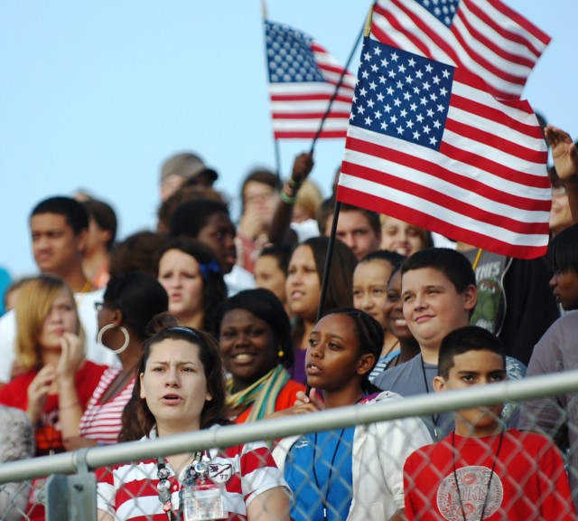 FORT HOOD, Texas- Teachers and students wave flags and sing during a 9/11 Memorial Ceremony held at and hosted by Smith Middle School, Fort Hood, Sept. 10.  The ceremony was sponsored by the 1st Battalion, 8th Cavalry Regiment, 2nd Brigade Combat Tea...