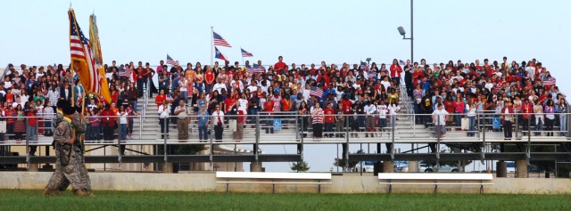 FORT HOOD, Texas- Staff and students stand for the Pledge of Allegiance as the color guard from the 1st Battalion, 8th Cavalry Regiment, 2nd Brigade Combat Team, 1st Cavalry Division, marches across Smith Middle School's football field during the 9/1...