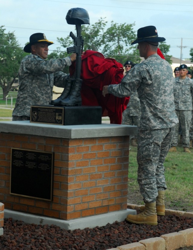 FORT HOOD, Texas-Lt. Col. Nathan Cook (right), the commander of 3rd Battalion, 82nd Field Artillery Regiment, 2nd Brigade Combat Team, 1st Cavalry Division, and Command Sgt. Maj. Carlos SotoBonilla, unveil a new memorial, Sept. 10, dedicated to the s...