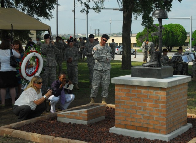 FORT HOOD, Texas-Izayah Polk (middle kneeling), takes a photo, Sept. 10, during the  memorial unveiling dedicated to his father and five other Soldiers killed while serving with 3rd Battalion, 82nd Field Artillery Regiment, 2nd Brigade Combat Team, 1...