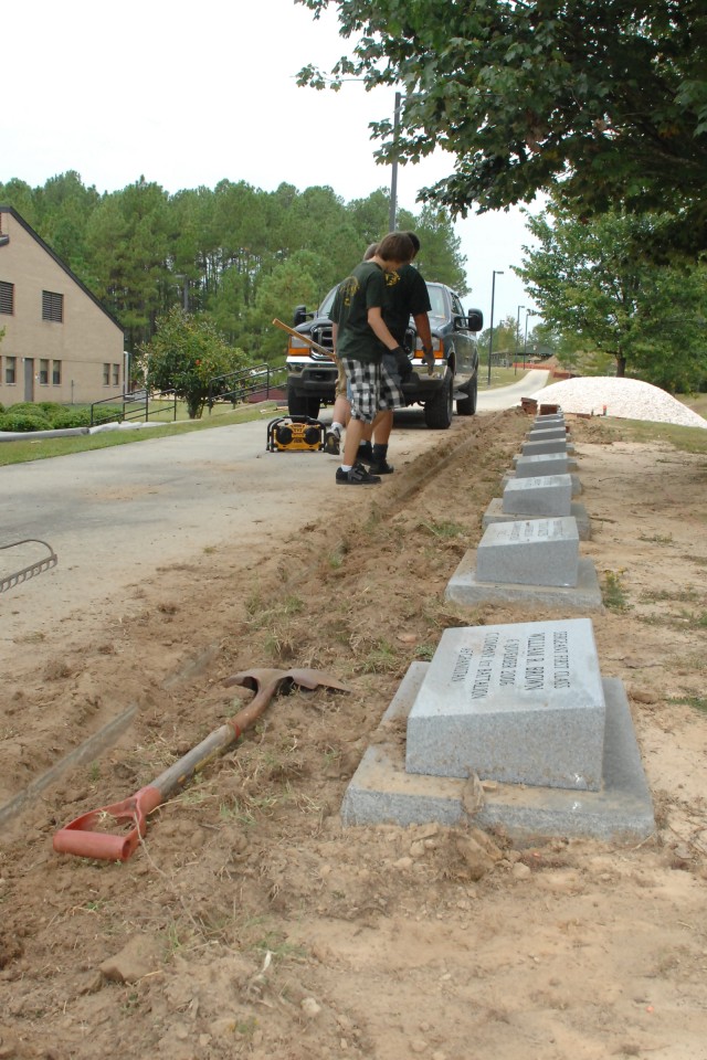 Boy Scouts from Troop 40, Fayetteville, N.C., landscape the new memorial walk for the 3rd Special Forces Group on 9/11