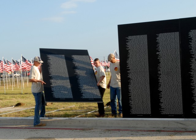 KILLEEN, Texas-Soldiers from 1st Air Cavalry Brigade, 1st Cavalry Division, help set up the traveling Vietnam Veterans Memorial, part of the American Veterans Traveling Tribute, at the Killeen Civic and Conference Center, Sept. 9. The tribute also in...