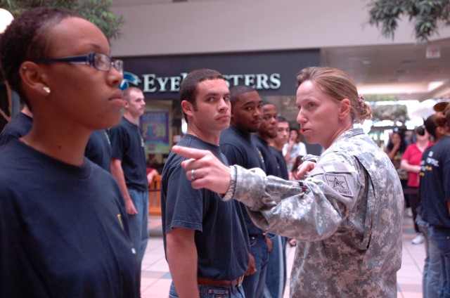 TEMPLE, Texas - Staff Sgt. Heather Hathaway, a recruiter at the Army Recruiting Station, Temple, Texas, tells the future Soldiers how to properly align themselves in a platoon formation, 9 Sept., before an Oath of Enlistment ceremony for the...