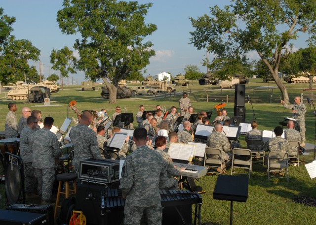 FORT HOOD, Texas - Chief Warrant Officer 2 Michael Moore (far right), from Austin, commander and band master of the 1st Cavalry Division Band, conducts the band while they play "Preserve the Legend March," written by Peter Giles, at the 1st Cavalry D...