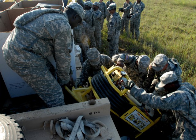 FORT HOOD, Texas - Soldiers from Company E, 1st Attack Reconnaissance Battalion, 227th Aviation Regiment, 1st Air Cavalry Brigade, 1st Cavalry Division, work together to unload fire extinguishing equipment on the forward arming and refueling point, h...