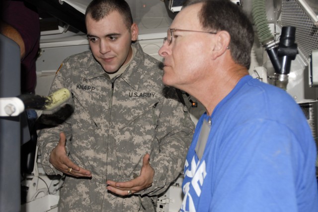 FORT HOOD, Texas-Sgt. Kevin Knapp, a tanker with 3rd Brigade Combat Team, 1st Cavalry Division, explains how to load the main gun of an M1A2 Tank to Mike Wilburn, a member of the Board of Trustees in Copperas Cove, Texas. Wilburn and other leaders...