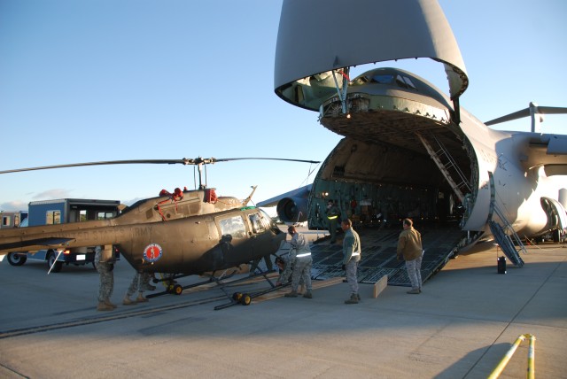 Soldiers with the 1-224 Aviation Security and Support Battalion, New York Army National Guard, unload an OH-58 Kiowa, Sept.17, at Air Force Base Ysterplaat Cape Town, South Africa from a C-5 Galaxy in preparation for the Africa Aerospace and...