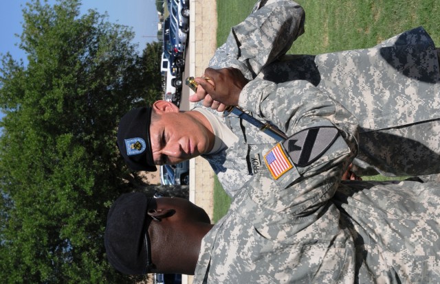 First Sgt. Richard Pomeroy, the new senior noncommissioned officer for the Headquarters and Headquarters Company, Special Troops Battalion, 15th Sustainment Brigade, receives the saber from Command Sgt. Maj. Clarence Miller, the battalion's senior...