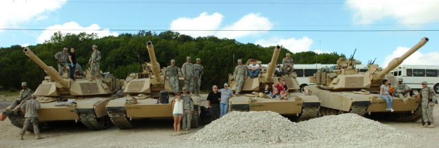 FORT HOOD, Texas - Soldiers from 2nd Platoon, Company D, 1st Battalion, 8th Cavalry Regiment, 2nd Brigade Combat Team, 1st Cavalry Division, and their spouses sit upon M1A2 Abrams main battle tanks during the Company C and D, 1st Bn., 8th Cav. Regt. ...