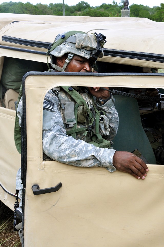 FORT HOOD, Texas - Capt. Roland Pugh, battery commander for Battery C, 2nd Battalion, 20th Field Artillery Regiment, 41st Fires Brigade, calls in a situation report after an indirect fire during Table XV battery level evaluation training on Fort Hood...