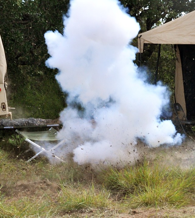 FORT HOOD, Texas - A loud bang and puff of smoke fills the air as Soldiers with Battery C, 2nd Battalion, 20th Field Artillery Regiment, receives indirect fire at the battery operation center during the Table XV battery level evaluation training on N...