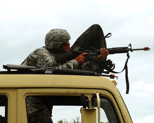 FORT HOOD, TEXAS - Staff Sgt. Juan Rodriguez, a food service specialist with Headquarters and Headquarters Company, 589th Brigade Support Battalion, 41st Fires Brigade, returns fire on enemy forces as his convoy encountered an attack during the briga...