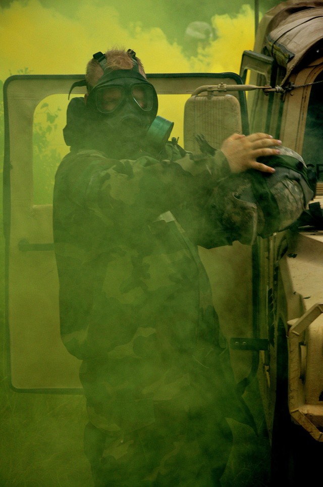 FORT HOOD, Texas - 1st Lt. Bill Truett, operations and fire direction officer for Battery C, 2nd Battalion, 20th Field Artillery Regiment, 41st Fires Brigade, prepares to achieve mission oriented protective posture level four before being consumed...
