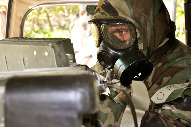 FORT HOOD, Texas - Spc. Joseph Vales, a Phoenix native and chemical agent specialist for Battery C, 2nd Battalion, 20th Field Artillery Regiment, calls in an NBC one report after a mortar attack released non-persistent nerve agent in the air...