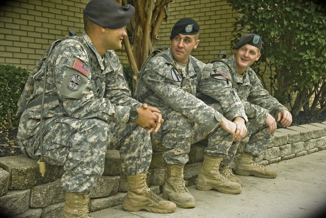 Cheyenne, Wyo. native Spc. Eric Brubaker (Center), a tanker with the 2nd Battalion 5th Cavalry Regiment, 1st Cavalry Division cops a well deserved squat outside 2-5 CAV battalion headquarters with his first line supervisor Spc. Randy Meeks (left)...
