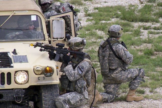 FORT HOOD, Texas - Troopers from C Troop, 6th Squadron, 9th Cavalry Regiment, 3rd Brigade Combat Team, 1st Cavalry Division, pull security while conducting a cordon and search on the Boaz Combined Arms Combat Training Facility as part of a...