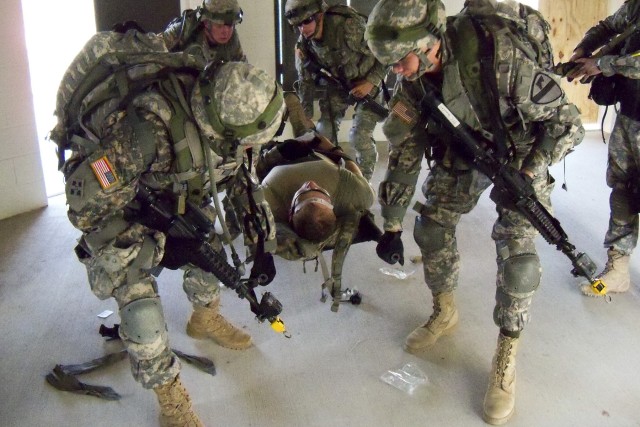 FORT HOOD, Texas - Troopers from 6th Squadron 9th Cavalry Regiment, 3rd Brigade Combat Team, 1st Cavalry Division, evacuate a casualty while conducting a cordon and search at the Boaz Combined Arms Combat Training Facility site as part of a...