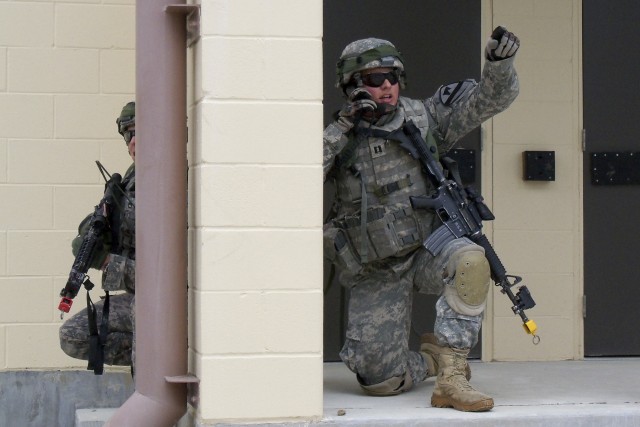 FORT HOOD, Texas - Capt. David Hanna from Montrose, Colo., directs his platoons while conducting a cordon and search at the Boaz Combined Arms Combat Training Facility as part of a Greywolf field training exercise Sept. 20-22. Hanna is a Troop...