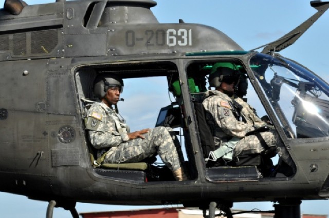 The New York National Guard Director of Joint Staff Brig. Gen. Renwick Payne and Chief Warrant Officer 3 Aaron Teichner (front) an aviator with Det. 1 A Co 1-224 Aviation Security and Support Battalion perform a demonstration flight in an OH-58 Kiowa...