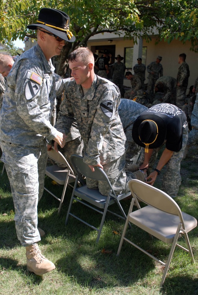 FORT HOOD, Texas - Brooklyn native, Command Sgt. Maj. Mervyn Ripley (left), the command sergeant major of the 1st Squadron, 7th Cavalry Regiment, 1st Brigade Combat Team, congratulates Eaton, Ohio, native, Spc. Jonathan Preston, a cavalry scout assig...