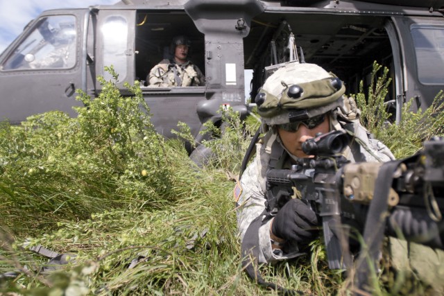 FORT HOOD, Texas-Staff Sgt. Joseph Cadriel, with 3rd Brigade Combat Team, 1st Cavalry Division, exits a UH-60 Blackhawk as part of an air assault, cordon, search and secure exercise at Elijah MOUT Facility. The exercise was part of the brigade's week...