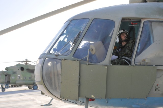 Afghanistan National Army Air Corps pilot conducts pre-flight checks