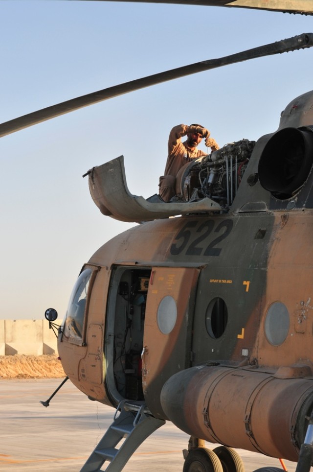 Afghan Air Force crew chief conducts pre-flight checks