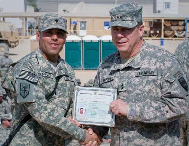 Army Maj. Gen. Timothy McHale coins Spc. Hamed Sikandary