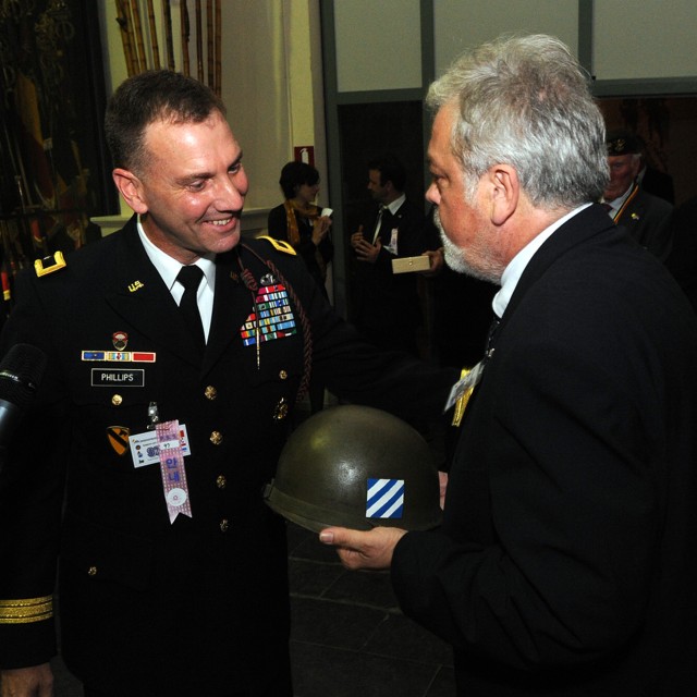Phillips presents memento to Belgian museum
