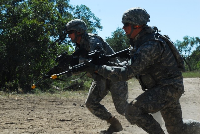FORT HOOD, Texas- 1st Lt. Ross Cargile (left), a fire direction officer, and Pfc. Nathanial Wyatt, a cannon crew member, both with B Battery, 3rd Battalion, 82nd Field Artillery Regiment, 2nd Brigade Combat Team, 1st Cavalry Division, practice rushin...