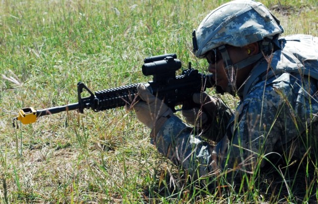 FORT HOOD, Texas- Spc. Samnang Phan, a field artillery automated tactical data systems specialist with B Battery, 3rd Battalion, 82nd Field Artillery Regiment, 2nd Brigade Combat Team, 1st Cavalry Division, peers through the scope of his M4 rifle for...