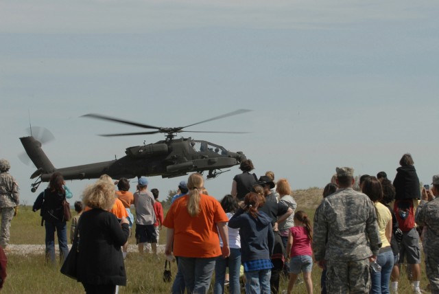 FORT HOOD, Texas-Family members of Soldiers from the 1st Attack Reconnaissance Battalion, 227th Aviation Regiment, 1st Air Cavalry Brigade, 1st Cavalry Division, look on as an AH-64D Attack helicopter lands during a battalion family day event,...