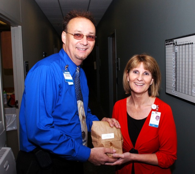 FORT HOOD, Texas - Dennis Horsch, administrator for the William R. Courtney Texas State Veterans Home, Temple, Texas, hands his wife Vickie a bag with breakfast tacos made by Soldiers from Headquarters and Headquarters Company, 2nd Brigade Combat...