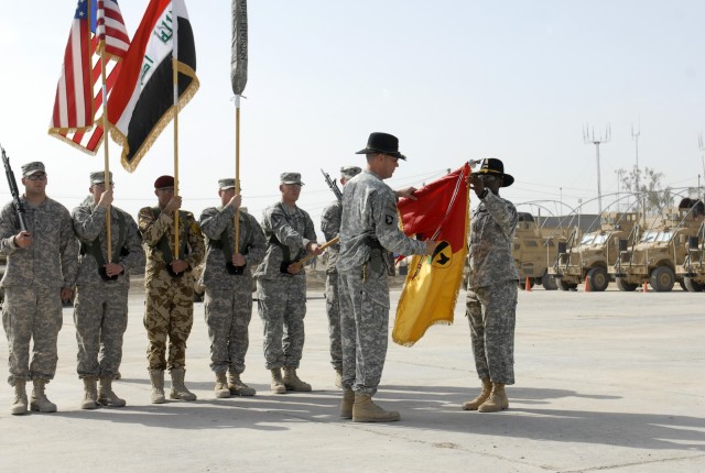 CONTINGENCY OPERATING SITE MAREZ, Iraq -Col. Brian Winski (left), commander of the 4th Advise and Assist Brigade, 1st Cavalry Division, and Command Sgt. Maj. Antoine Overstreet, uncase their colors during a transfer of authority ceremony, Oct. 18. So...