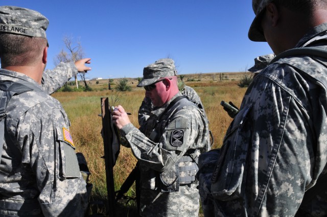 Staff Sgt. Bryan Ginnetti checks to see if his point is correct during the land navigation portion of the 100th Missile Defense Brigades field training exercise Sept. 23 at Fort Carson, in Colorado Springs, Colo. The FTX events also included the HMMW...