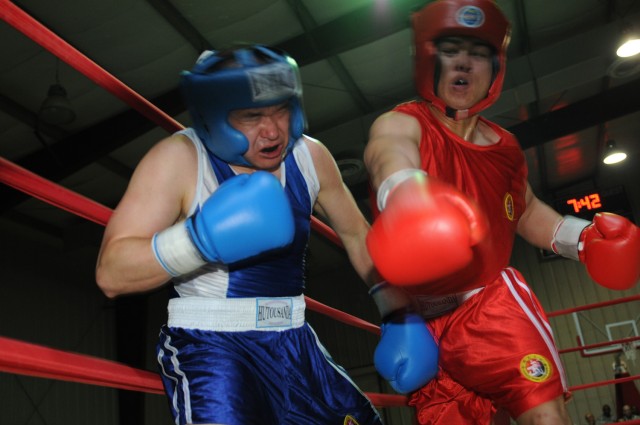 Air Force Capt. Joey Ingram (left), an intelligence, survey and reconnaissance officer with the 24th Intelligence Squadron, liaison officer to the 1st Armored Division, USD - C, and a Chattanooga, Tenn., native, cringes Oct. 9 after his opponent,...
