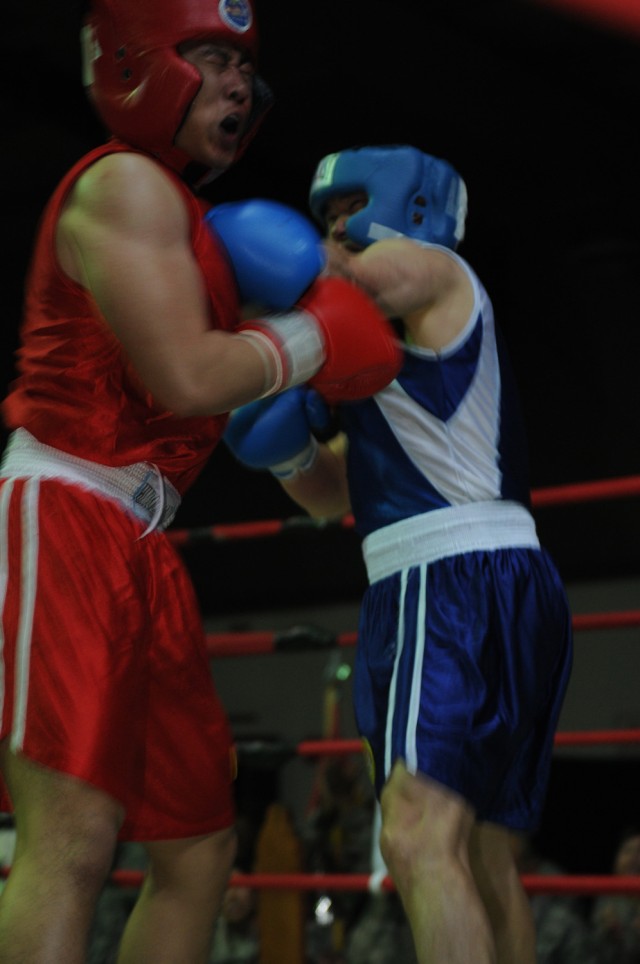 Air Force Capt. Joey Ingram (left), an intelligence, survey and reconnaissance officer with the 24th Intelligence Squadron, liaison officer to the 1st Armored Division, USD - C, and a Chattanooga, Tenn., native, follows through with a punch to his op...