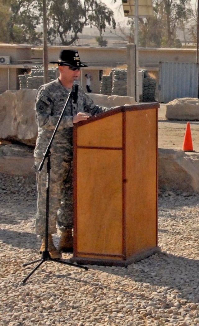 CONTINGENCY OPERATING SITE MAREZ, Iraq - Lt. Col. Eric Land, commander of the 4th Brigade Special Troops Battalion, 4th Advise and Assist Brigade, 1st Cavalry Division, speaks to his troops and guests after uncasing the battalion colors and...