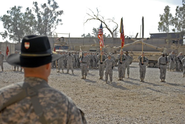 CONTINGENCY OPERATING SITE MAREZ, Iraq - Lt. Col. Robert Magee (foreground), commander of the 5th Battalion, 82nd Field Artillery Regiment, 4th Advise and Assist Brigade, 1st Cavalry Division, stands ready to uncase his battalion's colors during...