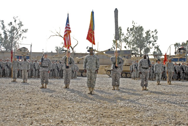 CONTINGENCY OPERATING SITE MAREZ, Iraq - Command Sgt Maj. Calvin Coler (center), with 5th Battalion, 82nd Field Artillery Regiment, 4th Advise and Assist Brigade, 1st Cavalry Division, stands before the battalion's recently uncased colors during...