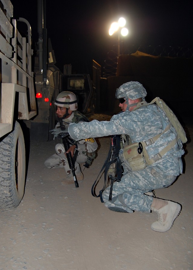 CONTINGENCY OPERATING SITE MAREZ, Iraq -Sgt. Curtis Jones (right), a cavalry scout, assigned to 1st Squadron, 9th Cavalry Regiment, 4th Advise and Assist Brigade, 1st Cavalry Division, trains his Iraqi counterpart ,Pvt. Fayez Ramthan Al, on how to sp...