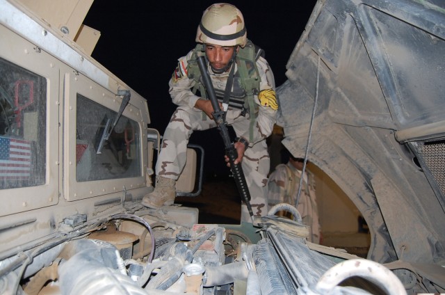 CONTINGENCY OPERATING SITE MAREZ, Iraq - Pvt. Fayez Ramthan Ali, an Iraqi Army Soldier, inspects a humvee for possible explosive devices during a vehicle search training class taught by troops from 1st Squadron, 9th Cavalry Regiment, 4th Advise and A...