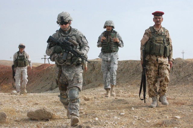 CONTINGENCY OPERATING SITE MAREZ, Iraq - Lt. Jeremiah Yaden (left), a platoon leader of with 1st Squadron, 9th Cavalry Regiment, 4th Advise and Assist Brigade, 1st Cavalry Division, joins troops from the Iraqi Security Forces on a patrol after...