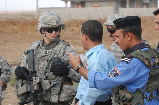 CONTINGENCY OPERATING SITE MAREZ, Iraq - Capt. John Nimmons (left), the company commander of B Troop, 1st Squadron, 9th Cavalry Regiment, 4th Advise and Assist Brigade, 1st Cavalry Division, speaks with leaders from an Iraqi police station about...