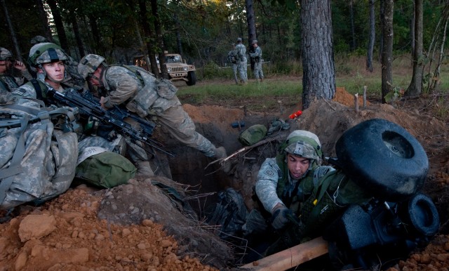 Soldiers leave their defensive fighting positions while preparing for an attack during a Full Spectrum Operation exercise in Ft. Polk, LA, Saturday, Oct. 23, 2010.  The Full Spectrum exercise focuses on facing and defeating a hybrid threat representi...
