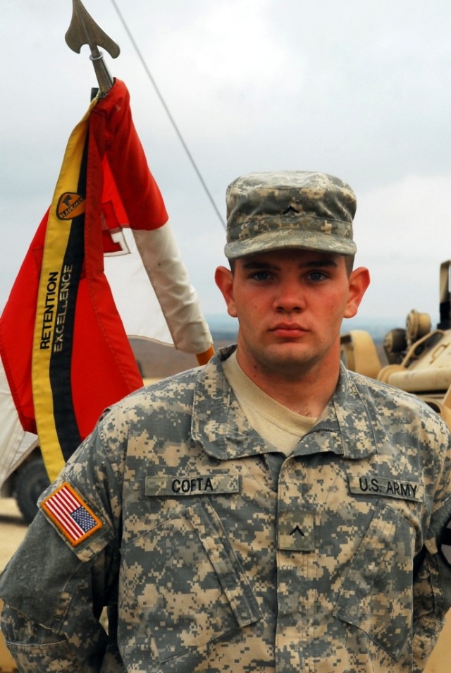 FORT HOOD, Texas- Pvt. Joseph Cofta, a medic with Company C, 1st Battalion, 5th Cavalry Regiment, 2nd Brigade Combat Team, 1st Cavalry Division, stands in front of his company guidon, Oct. 22. Cofta helped treat a woman who was having a seizure on...